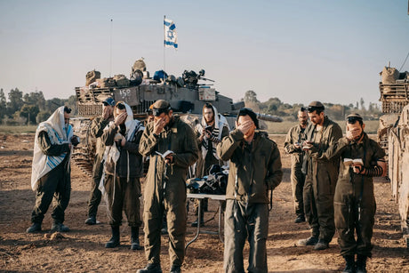 israeli soldiers pray outside Gaza Strip