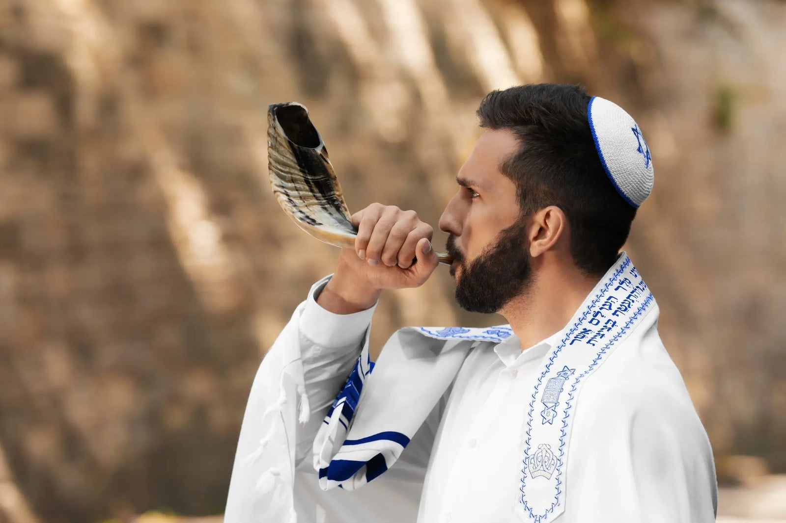 Jewish man blowing shofar on Rosh Hashanah